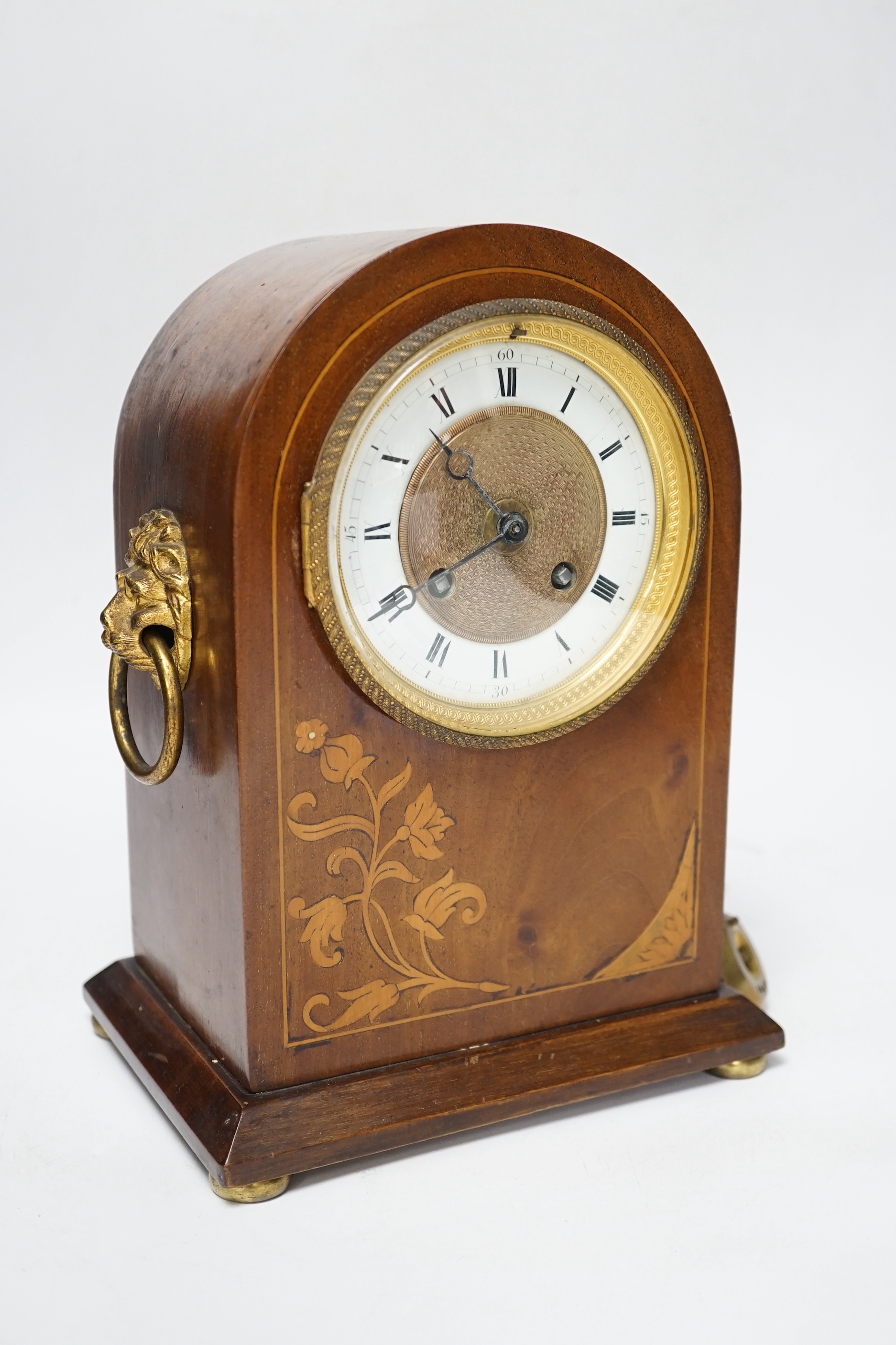 An Edwardian mahogany mantel clock, French movement striking on a coiled gong, 25cm high